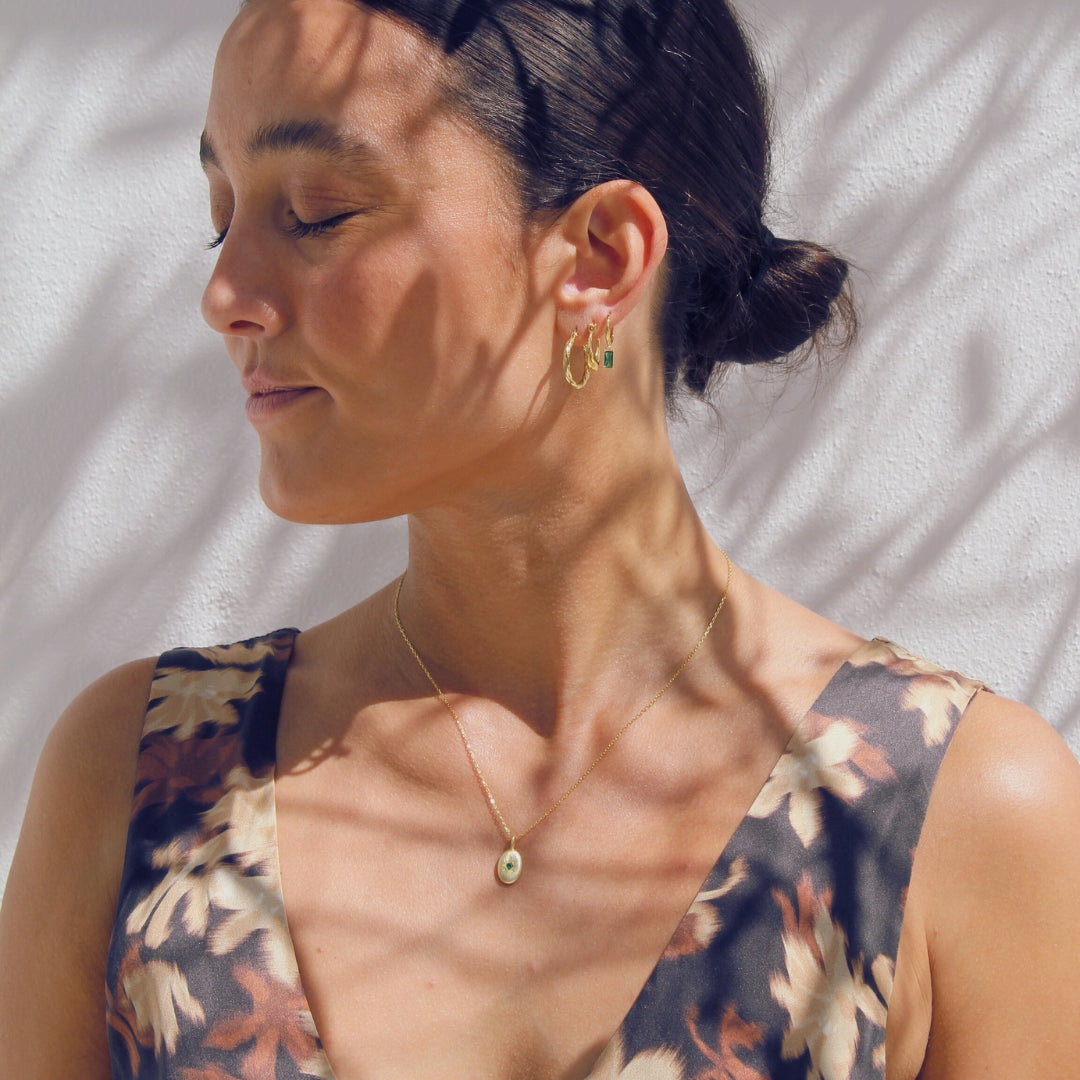 Woman wearing a floral dress with gold jewellery