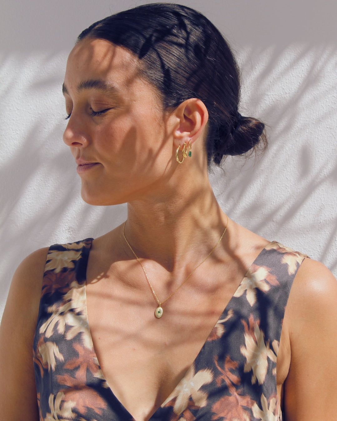 Woman wearing a floral dress with gold jewellery