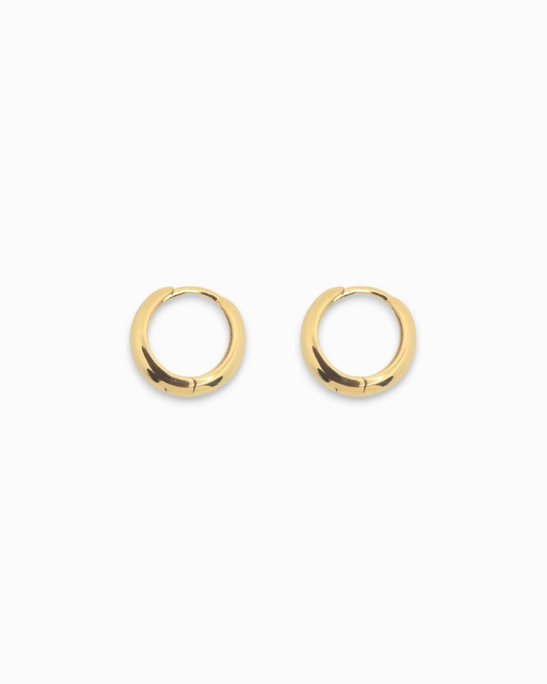 Pair of gold hoop huggie earrings on a white background