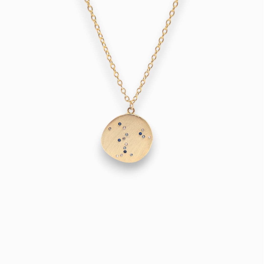 18k Gold necklace with a round pendant on a white background