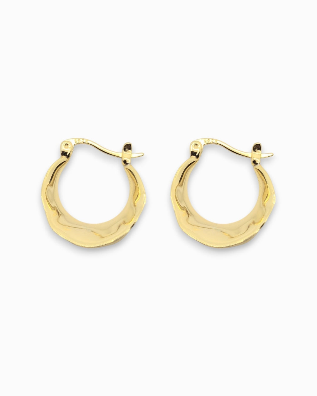 Gold hoop earrings on a white background