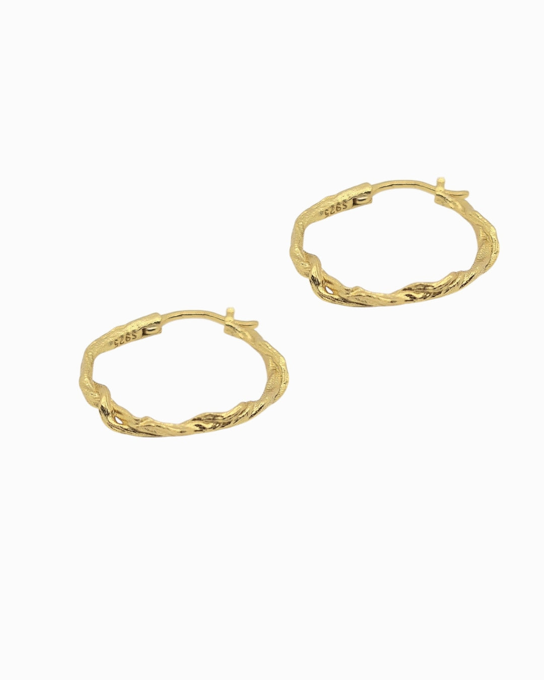 Gold hoop twist earrings on a white background