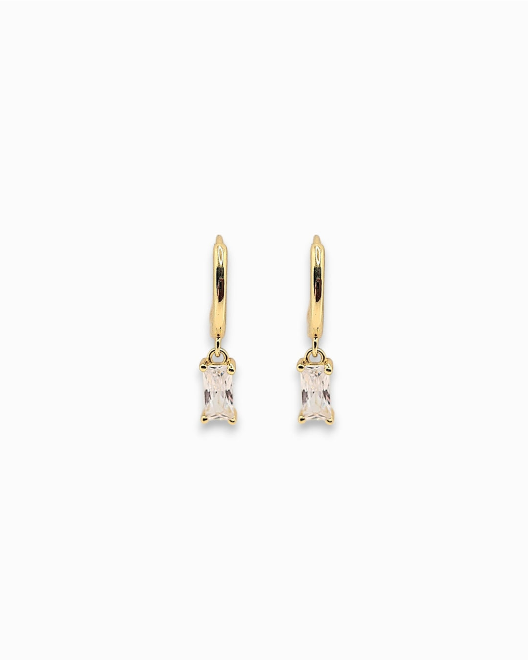 Gold pendant hoops earrings with clear gemstones on a white background