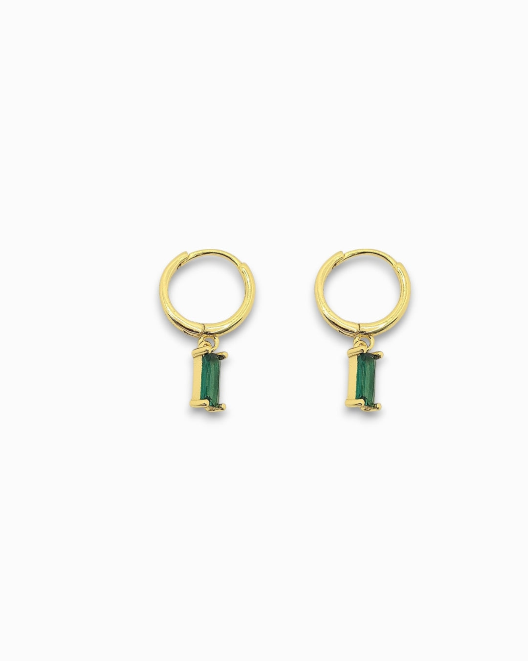 Gold pendant hoop earrings with green gemstones on a white background
