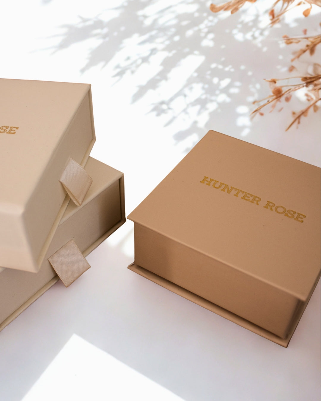 Two beige boxes with 'HUNTER ROSE' branding on a light background