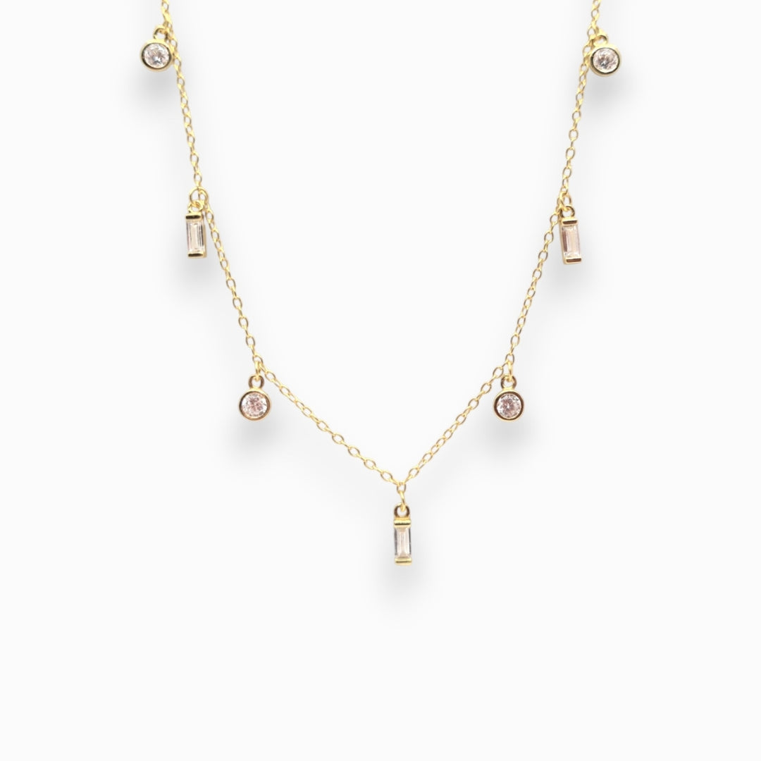 Gold necklace with small clear zirconians on a white background