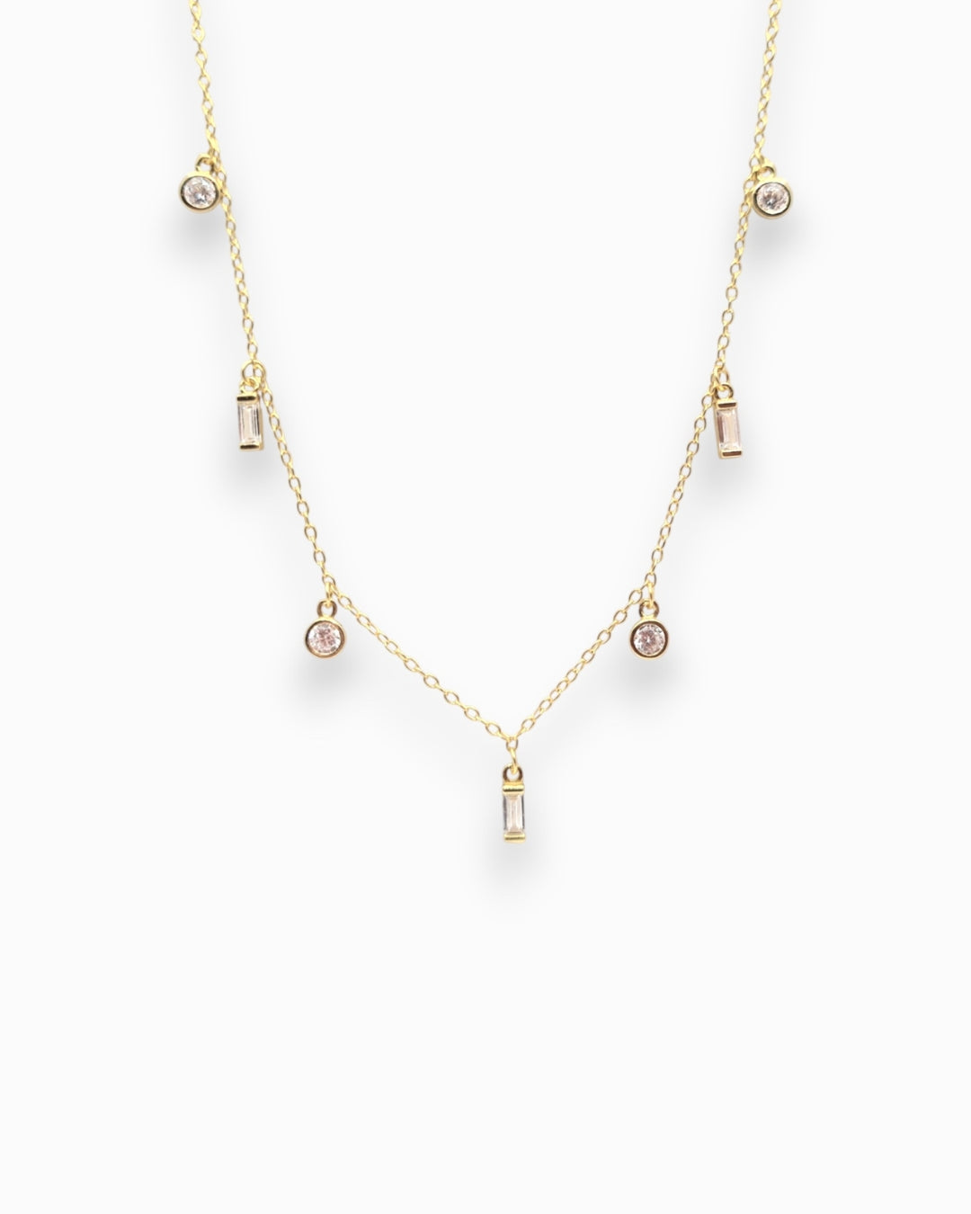 Gold necklace with small clear zirconians on a white background