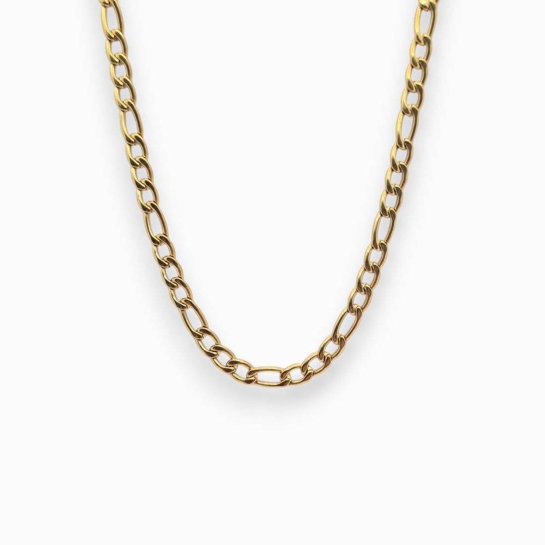 Gold Figaro chain necklace on a white background