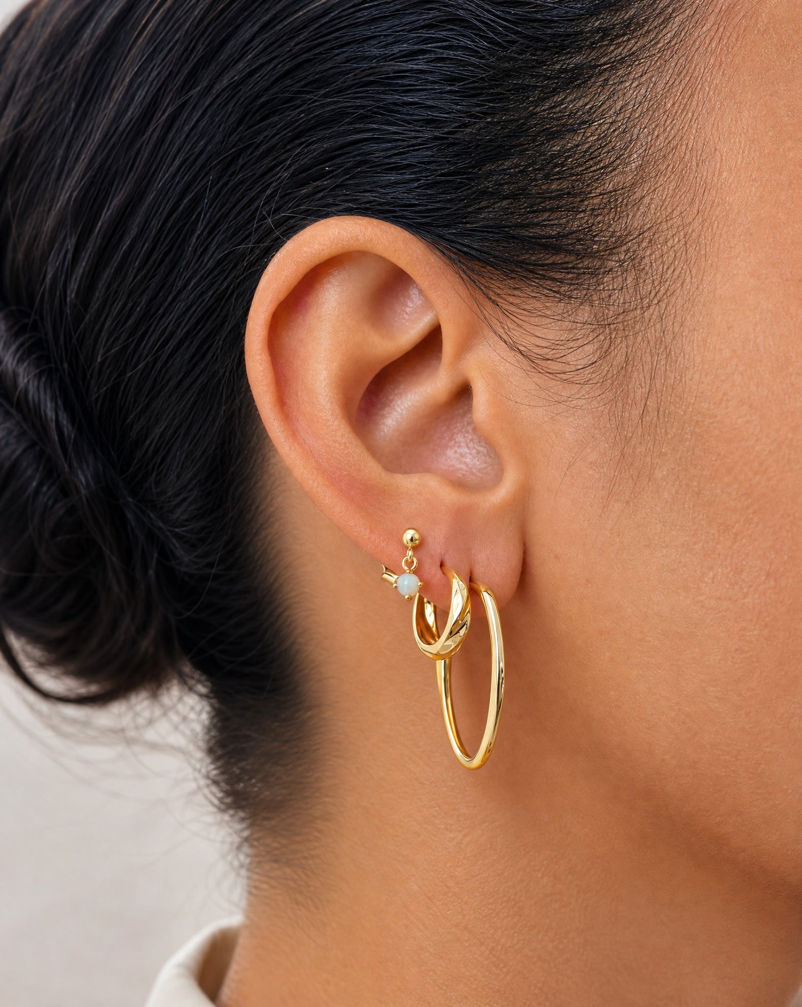 Close-up detail of the 18k gold plated finish on the Hunter Rose Aurora drop stud earrings.