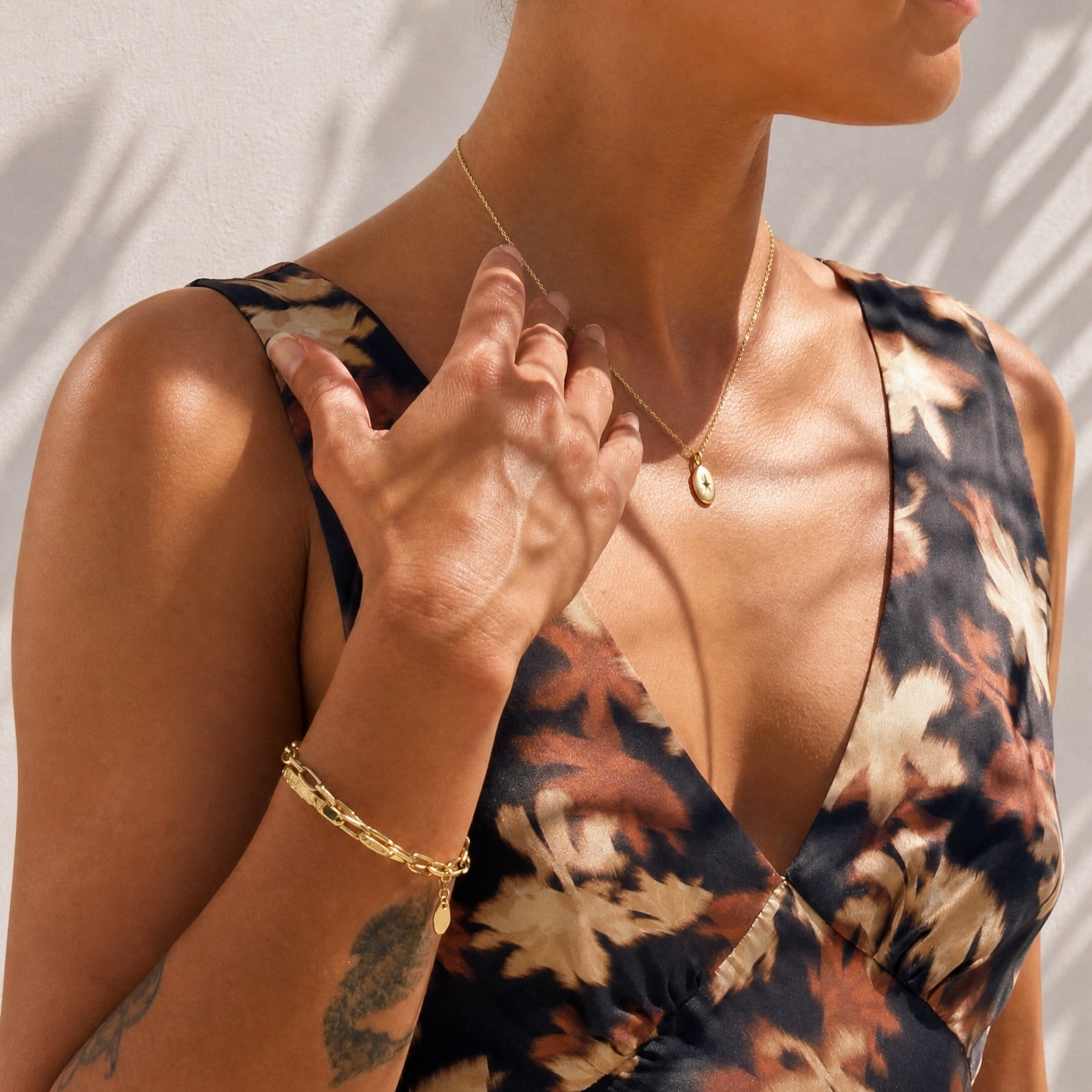 Lifestyle model wearing the Ava fine link gold plated jewellery by Hunter Rose.