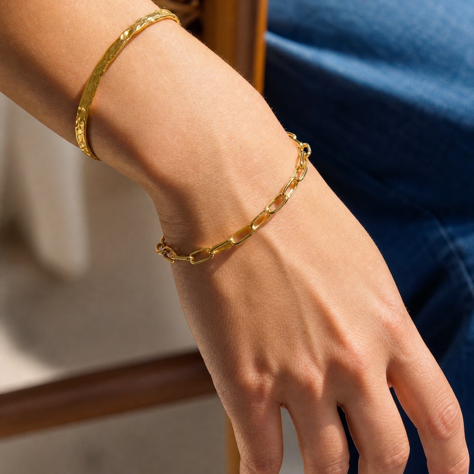 Close-up on the wrist wearing the Hunter Rose Ava 18k gold plated fine link chain bracelet.