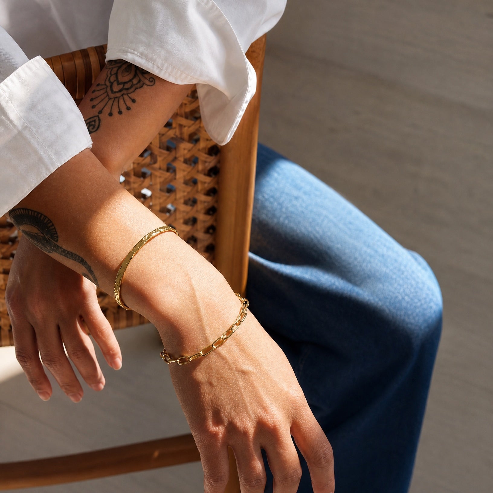 View of the arm and wrist wearing the Ava 18k gold plated sterling silver bracelet by Hunter Rose.