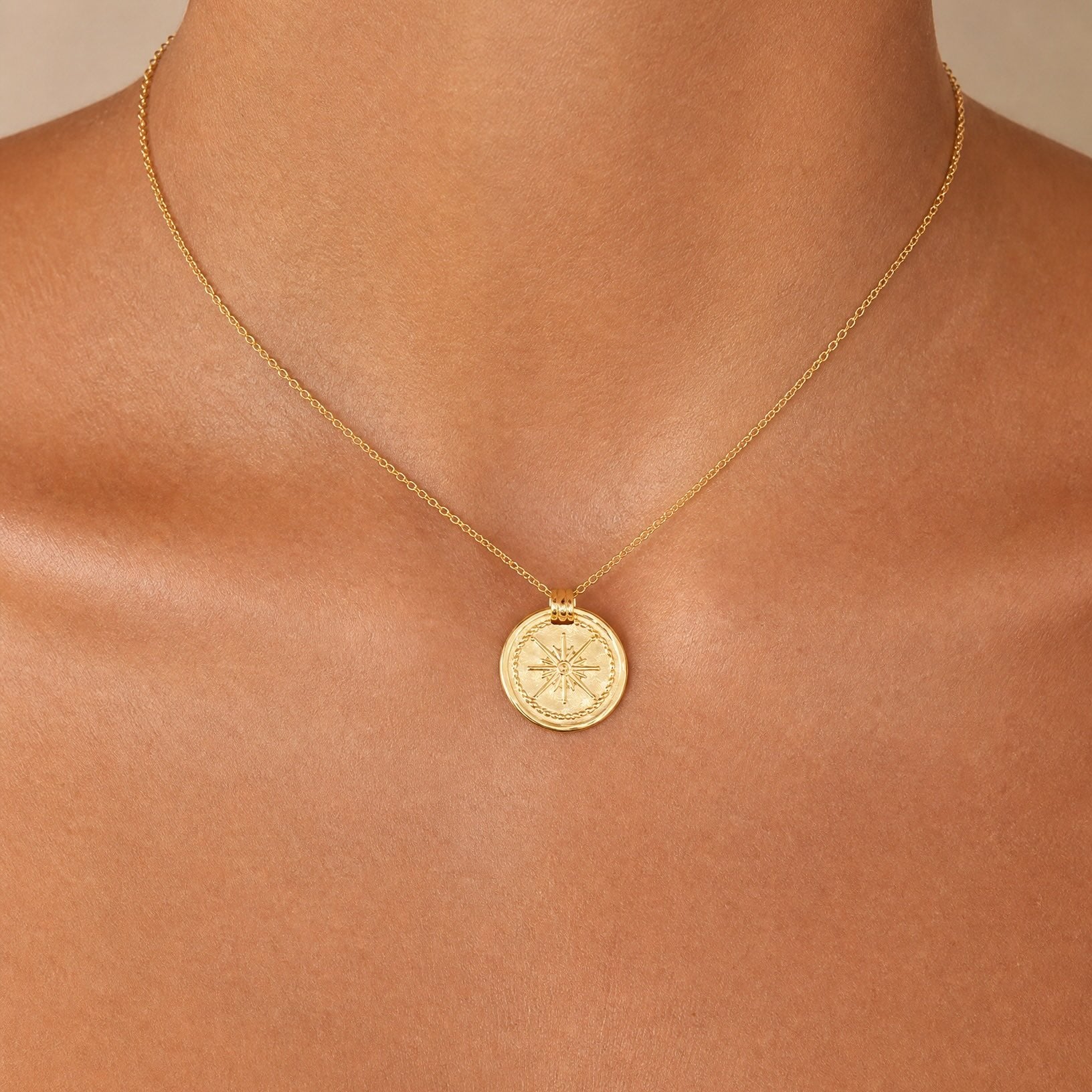 Close-up detail of the Bonny 18k gold plated sterling silver round pendant and fine chain by Hunter Rose