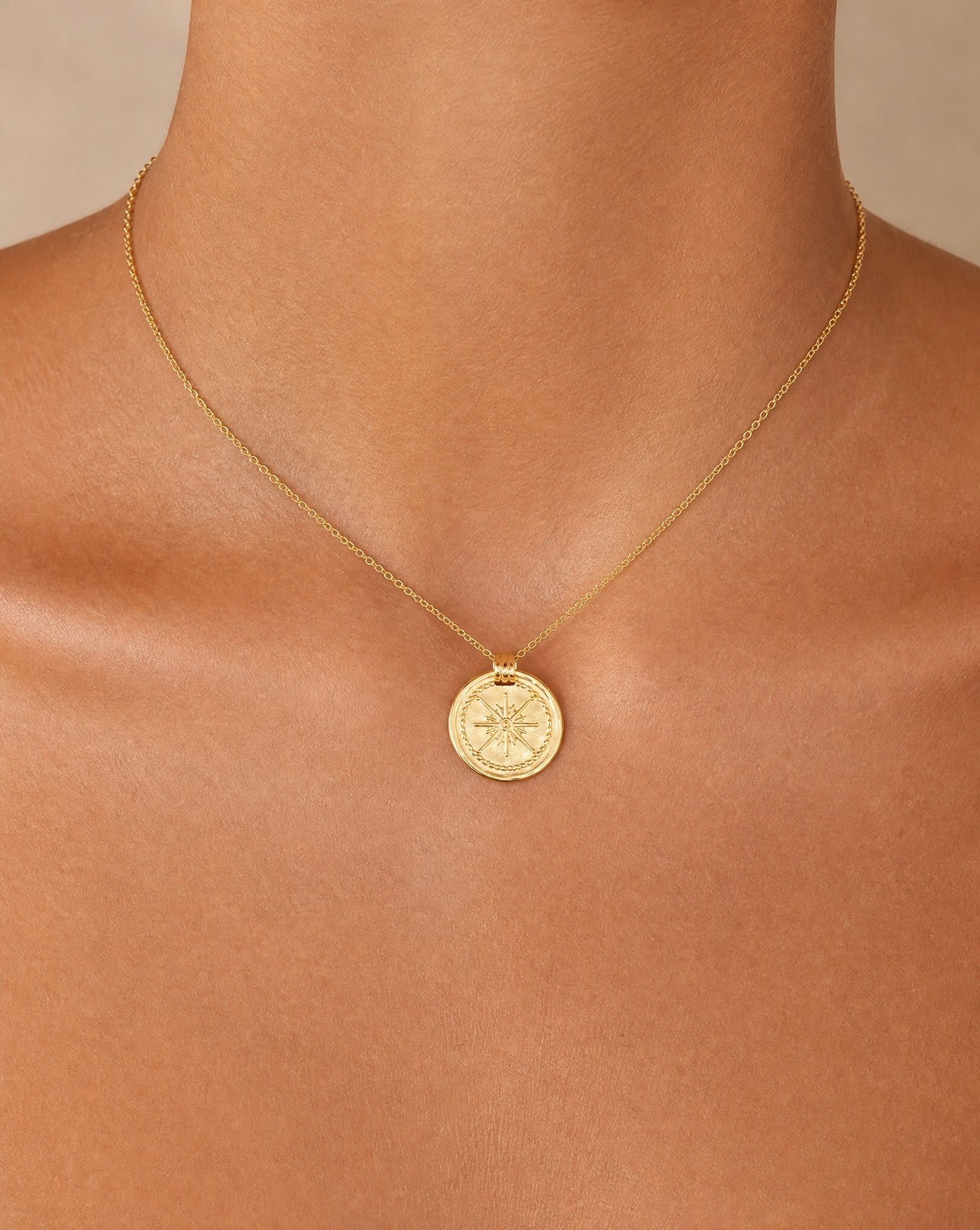 Close-up detail of the Bonny 18k gold plated sterling silver round pendant and fine chain by Hunter Rose