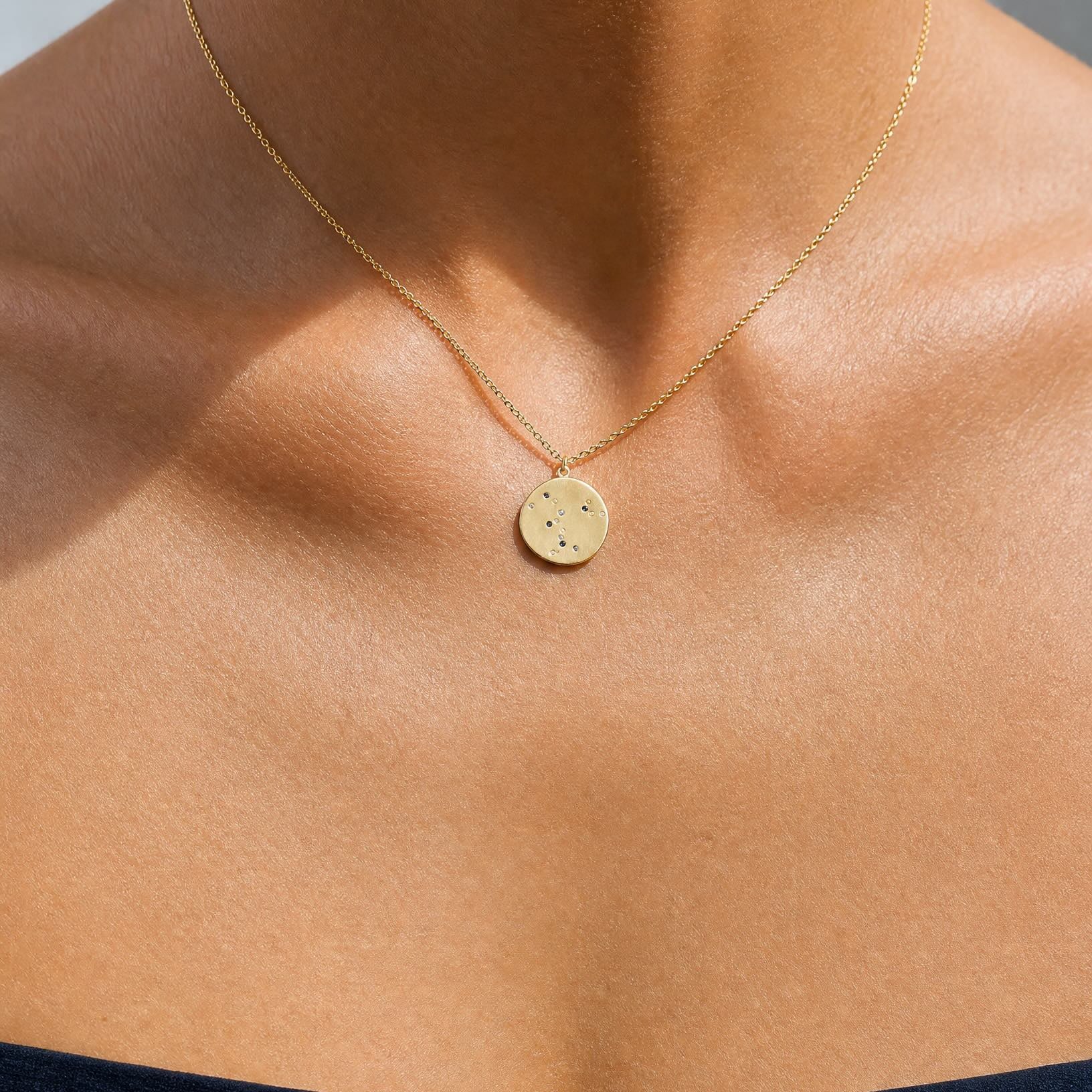 Close-up on the collarbone showcasing the Luna 18k gold constellation coin pendant necklace by Hunter Rose.
