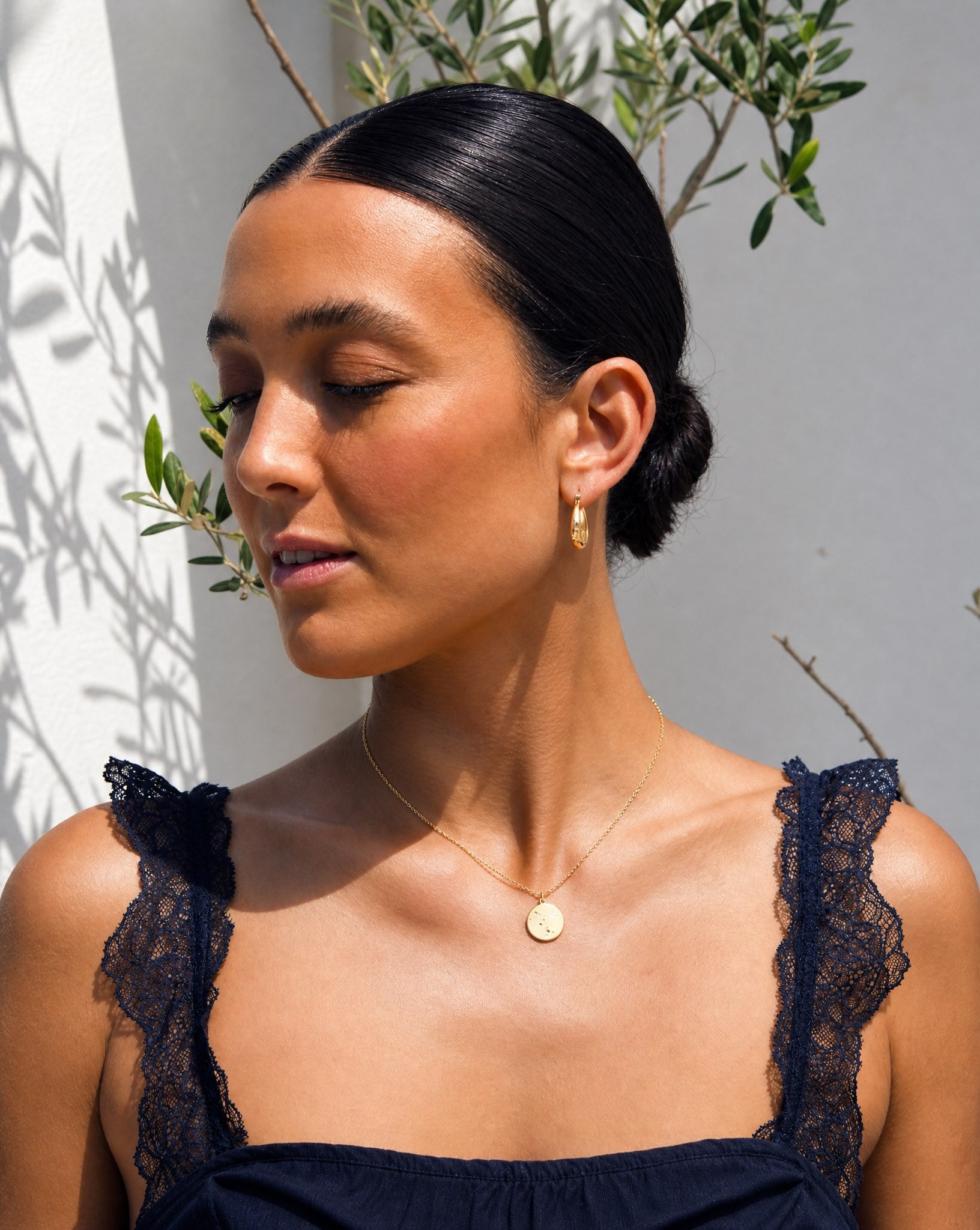 Lifestyle model wearing the Hunter Rose Luna 18k gold celestial coin necklace styled as everyday jewellery.