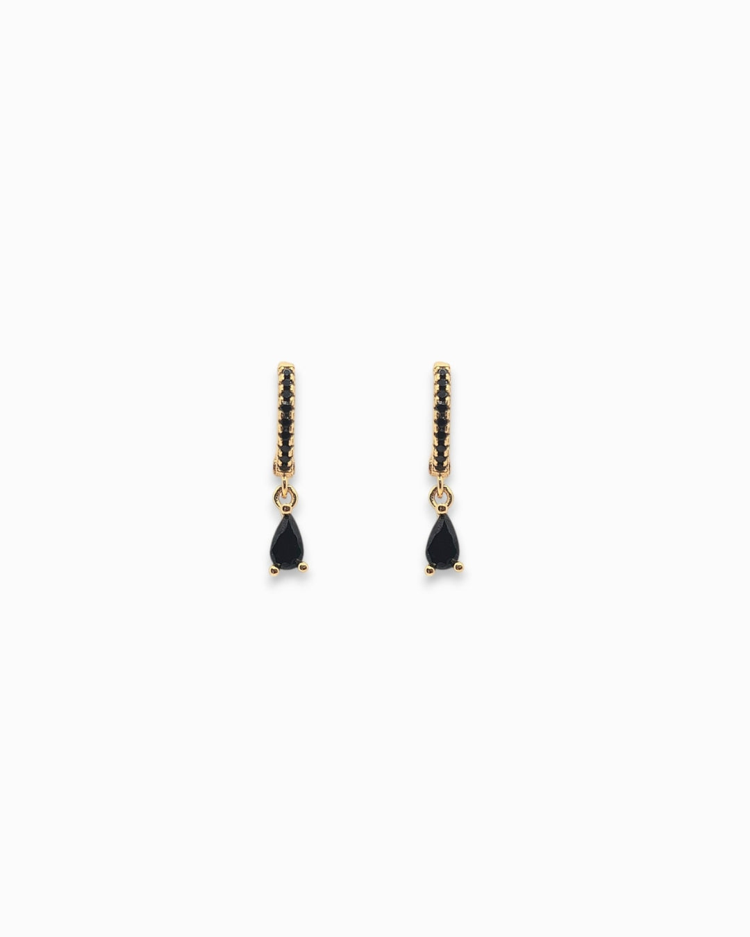 Pair of gold pendant hoop earrings with black teardrop stones on a white background