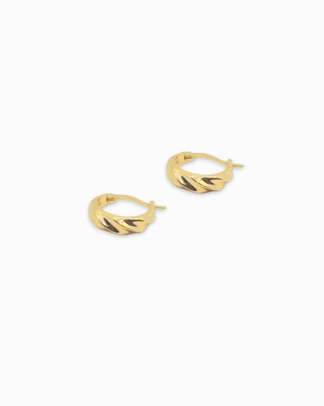 Gold hoop earrings on a white background