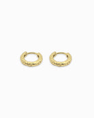 Gold hoop huggie earrings with a textured finish on a white background