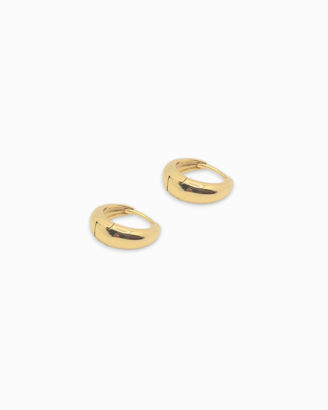 Lola huggie earrings on a white background