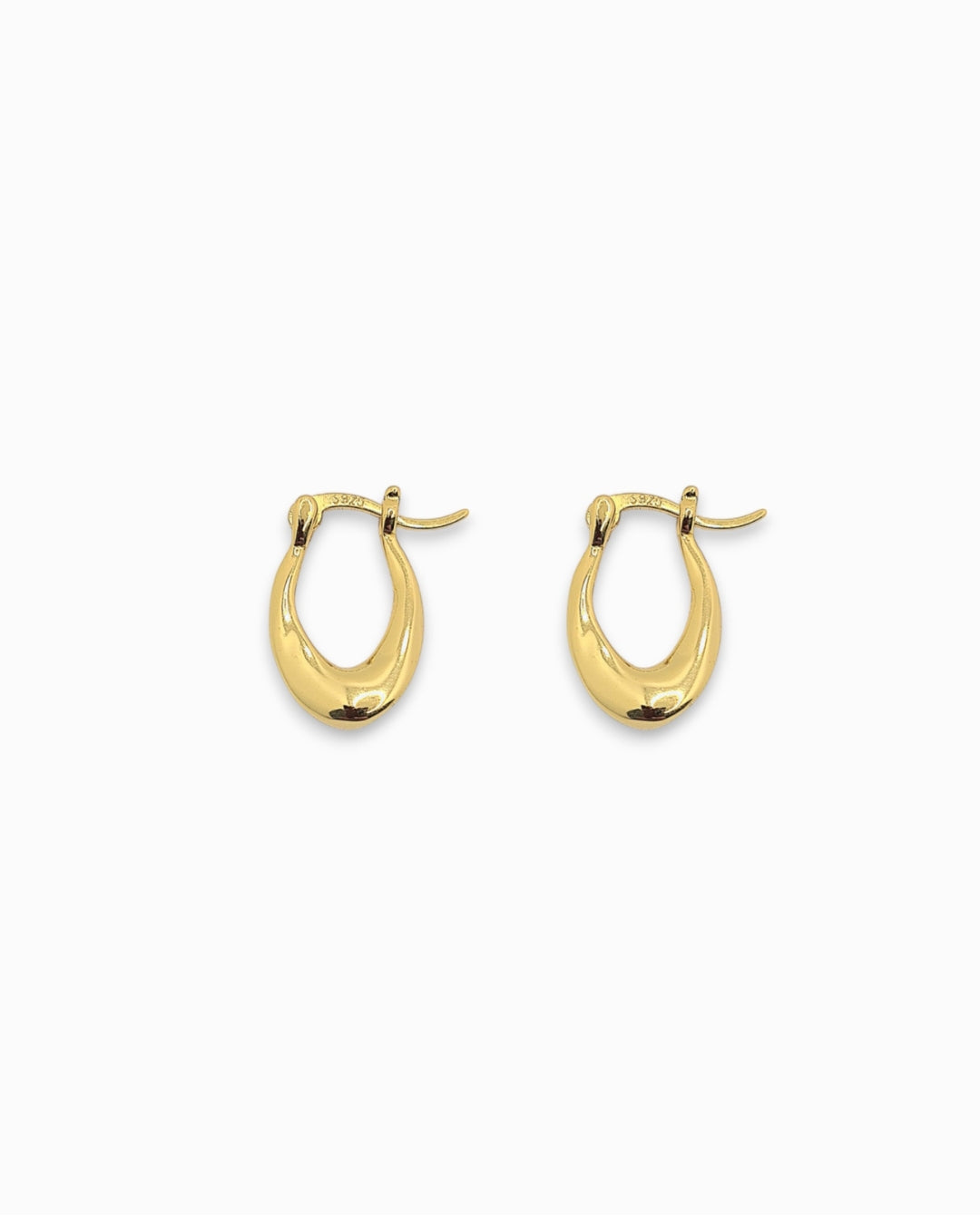 Gold teardrop shaped hoop earrings on a white background