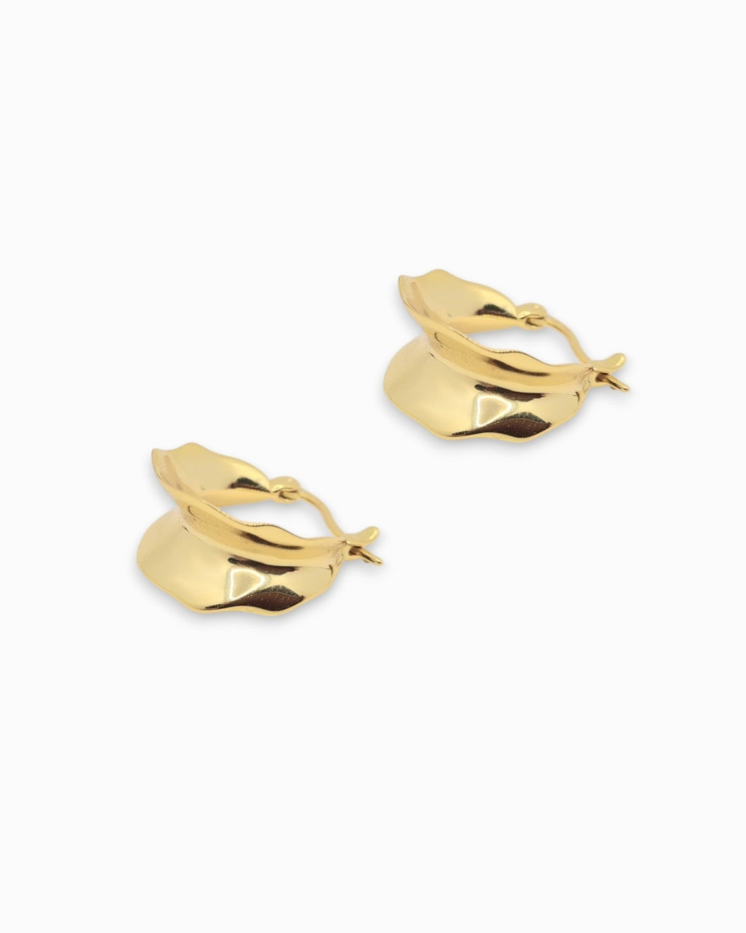 Gold hoop earrings with a interesting shape on a white background