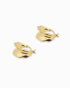 Gold hoop earrings with a interesting shape on a white background