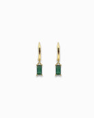 Gold pendant hoops earrings with green gemstones on a white background