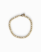 Gold Figaro chain bracelet on a white background