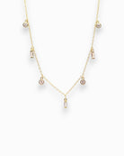 Gold necklace with small clear zirconians on a white background