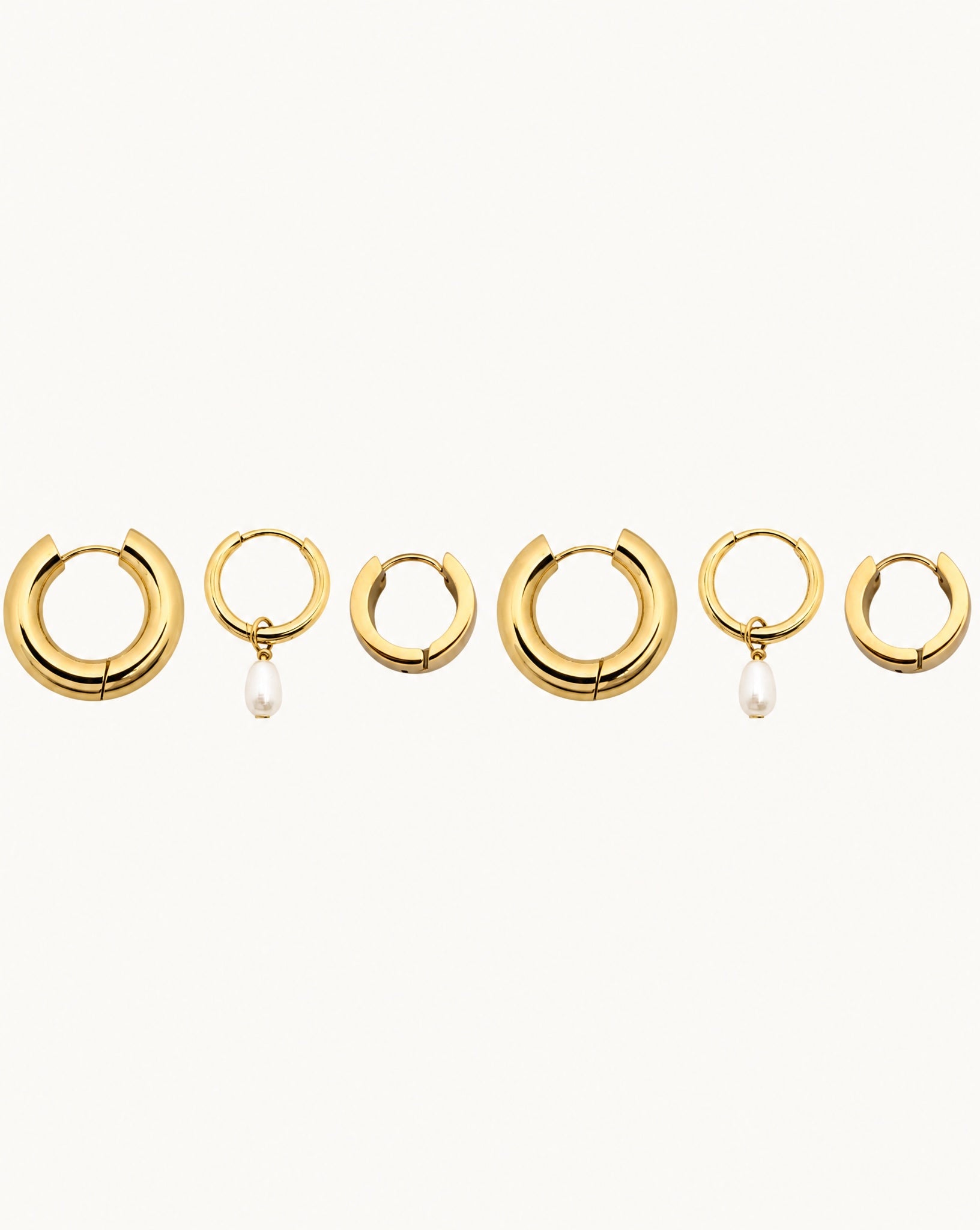 Studio view of the Hunter Rose 18k gold waterproof triple hoop earring stack featuring a pearl pendant.