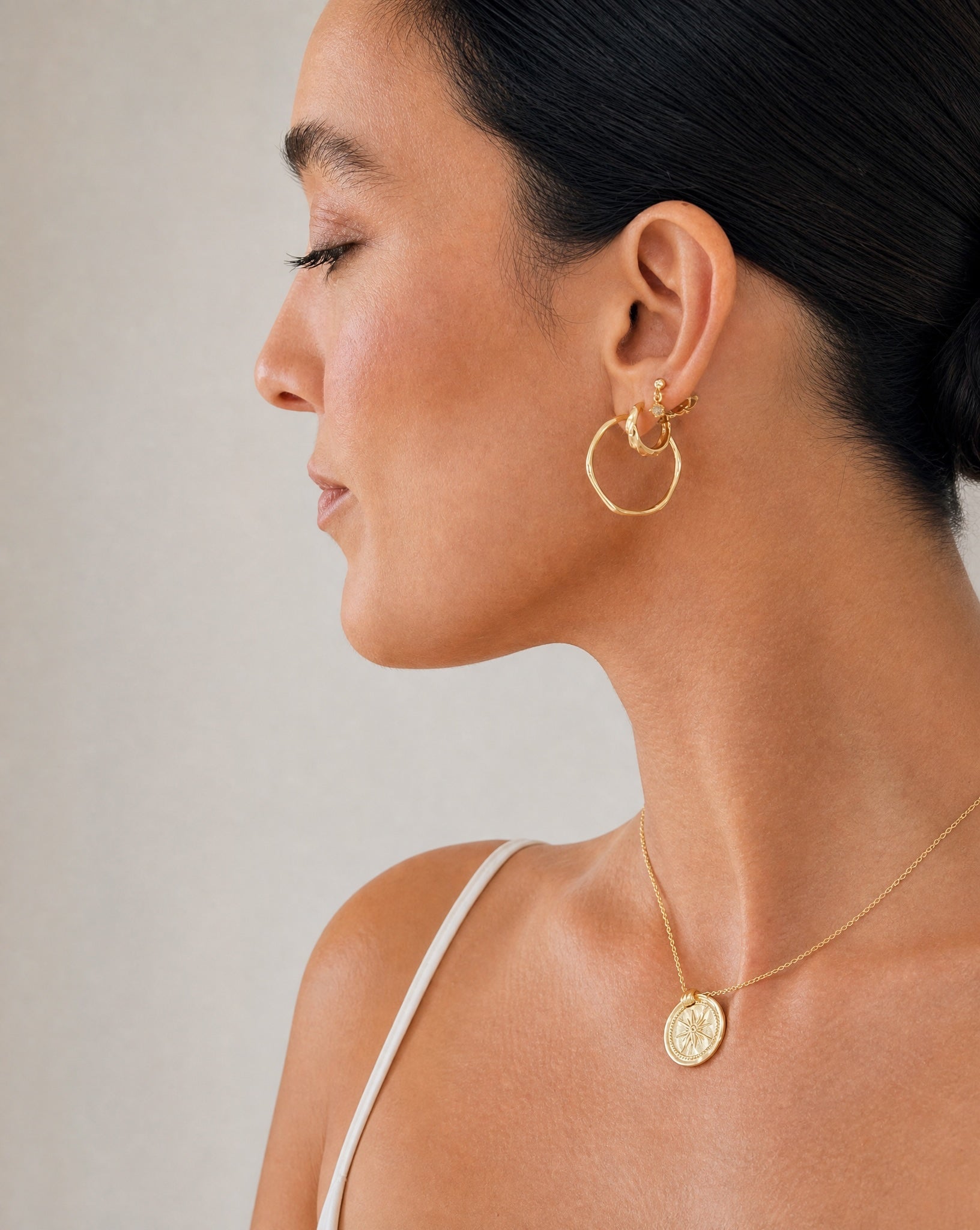 Model wearing the Hunter Rose Aurora 18k gold plated drop stud earrings.