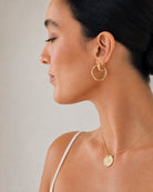 Model wearing the Hunter Rose Aurora 18k gold plated drop stud earrings.