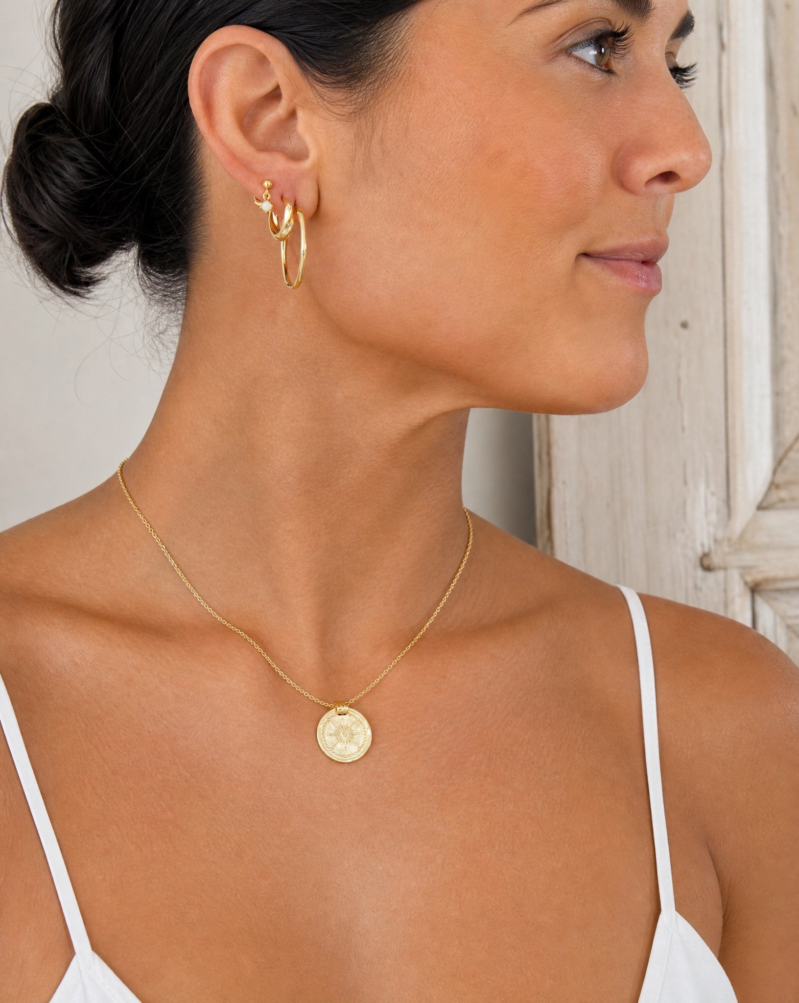 Lifestyle view of the Aurora gold plated drop studs styled as everyday demi-fine jewellery by Hunter Rose.
