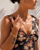 Lifestyle model wearing the Ava fine link gold plated jewellery by Hunter Rose.