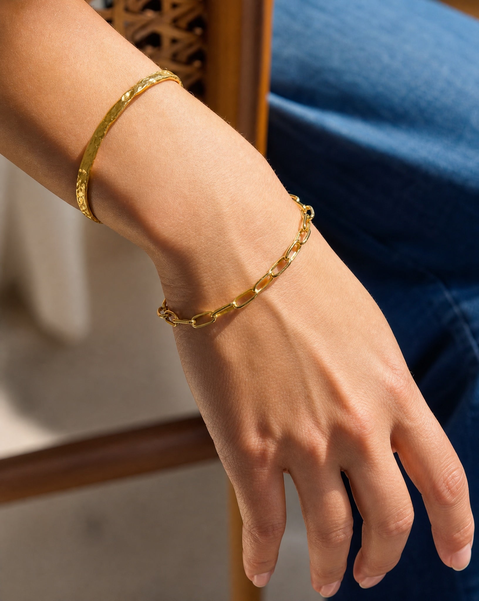 Close-up on the wrist wearing the Hunter Rose Ava 18k gold plated fine link chain bracelet.