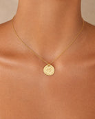 Close-up detail of the Bonny 18k gold plated sterling silver round pendant and fine chain by Hunter Rose