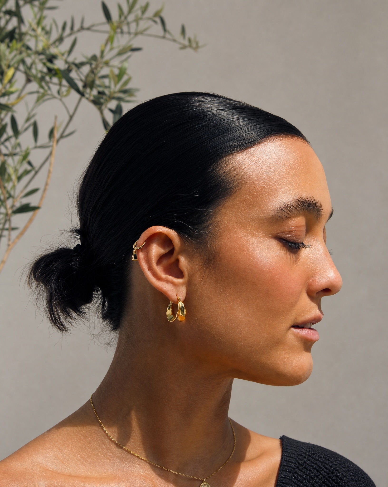 Lifestyle model wearing the Bronte black zirconia gold plated demi-fine jewellery by Hunter Rose.
