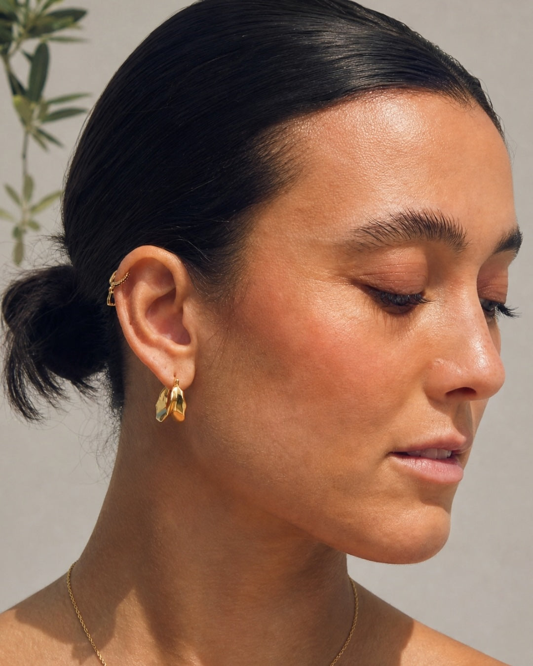The Hunter Rose Bronte 18k gold plated huggies with black zirconia, styled as everyday jewellery.