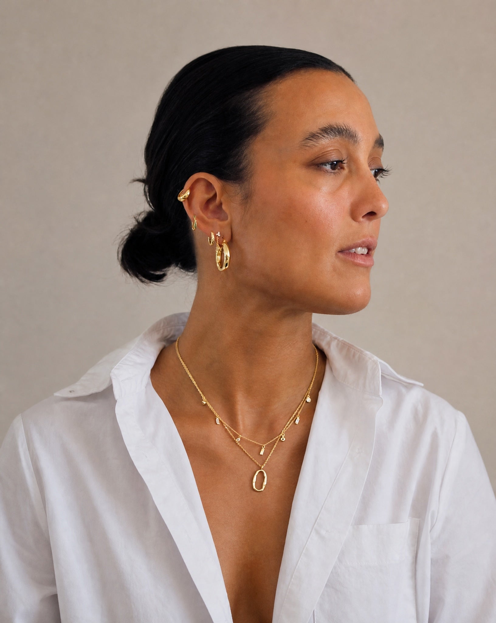 Model wearing the Hunter Rose Maisie 18k gold plated necklace with clear stones, styled with matching demi-fine jewellery.